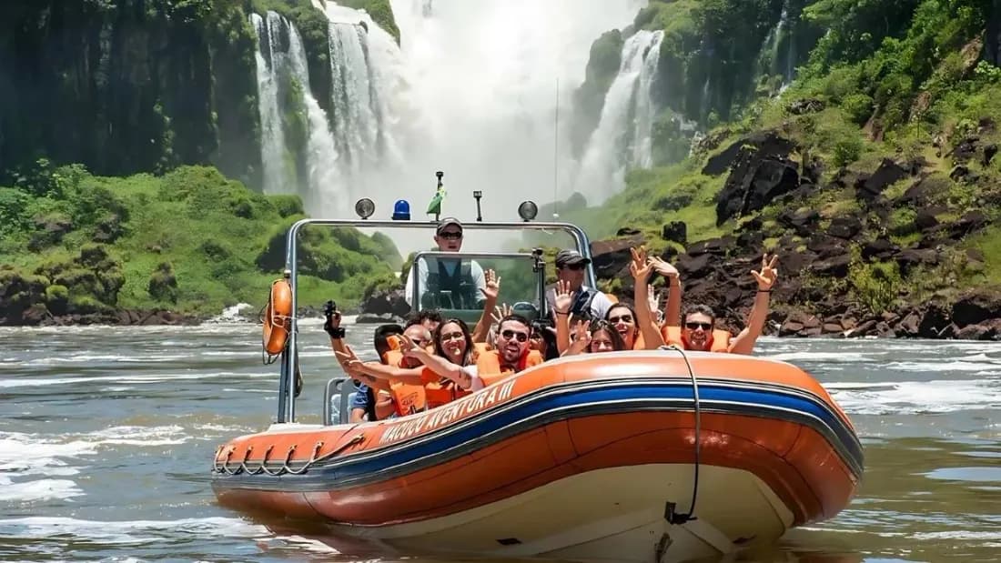 Macuco Safari inflatable boat carrying passengers toward the base of Iguazu Falls on the Iguazu River